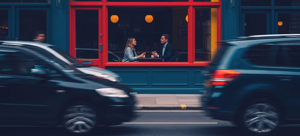 A couple of cars that are sitting in front of a building.